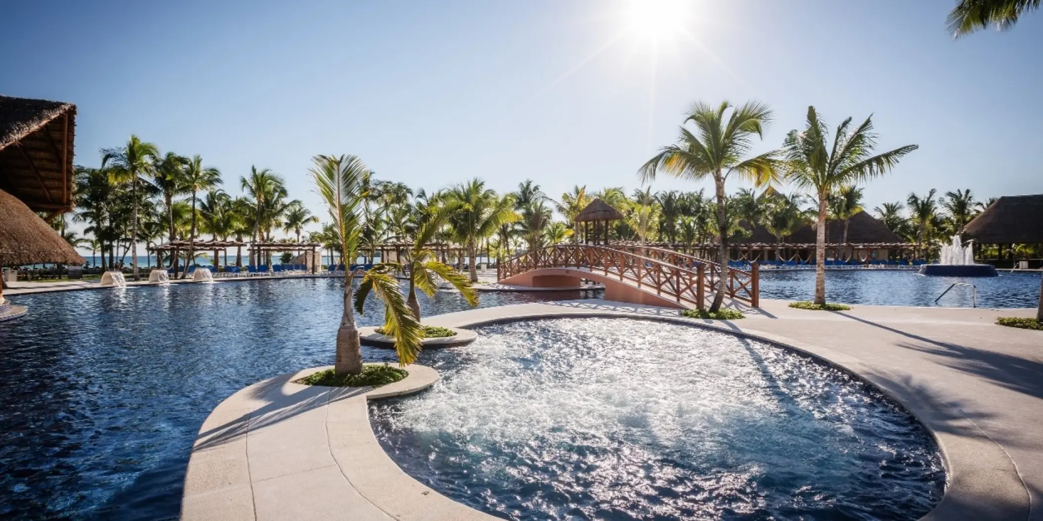 Barcelo Maya Caribe swimming pools with palm trees and footbridge, Riviera Maya