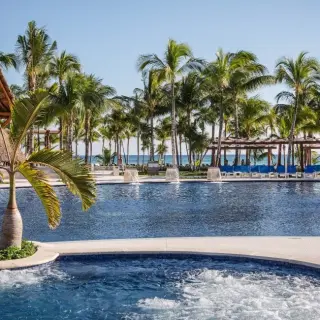 Barcelo Maya Caribe swimming pool with a swim-up bar and palm trees, Riviera Maya