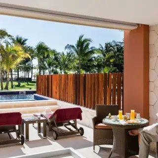 Swim-up room terrace with a private pool and patio furniture at Barcelo Maya Caribe, Riviera Maya