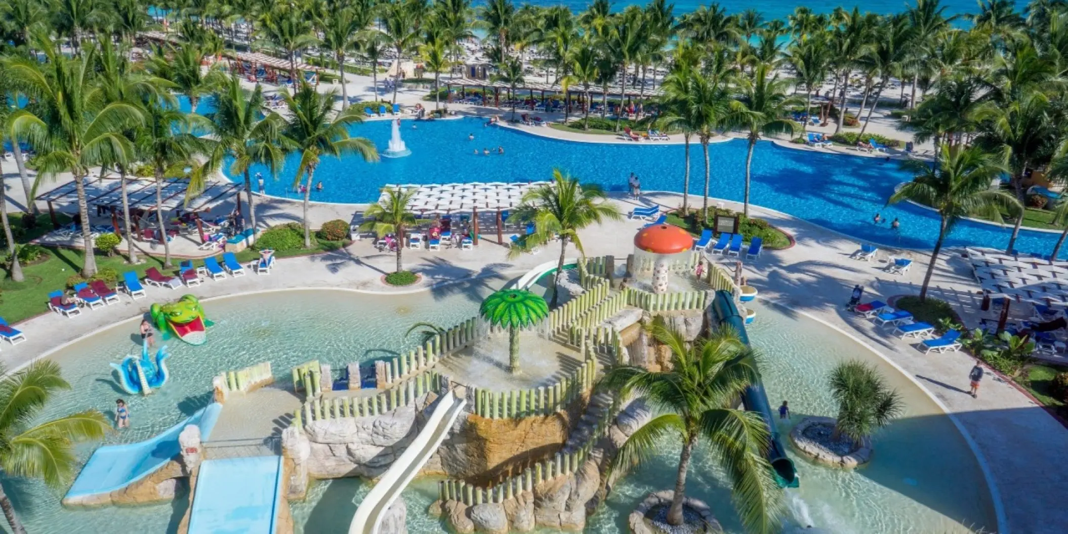 Water park with slides and palm trees at Barcelo Maya Colonial, Riviera Maya