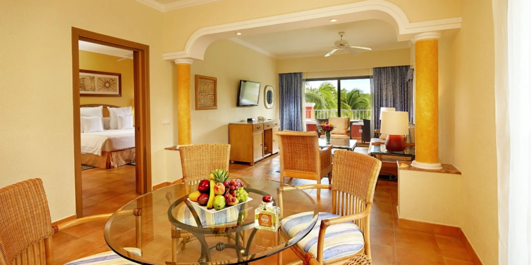 Barcelo Maya Colonial suite living and dining area with private balcony, Riviera Maya
