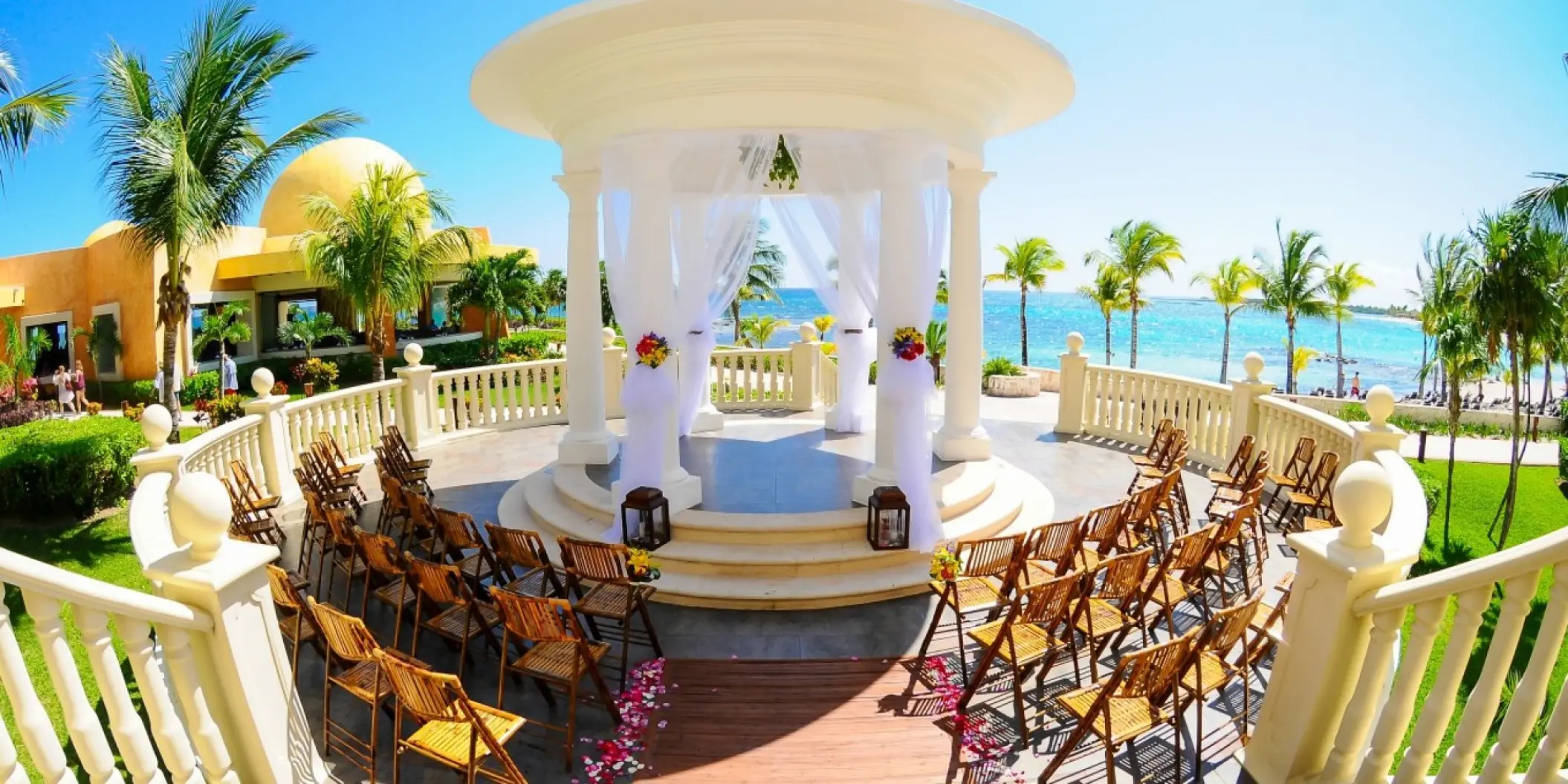 Oceanfront wedding gazebo with rows of chairs at Barcelo Maya Palace, Riviera Maya