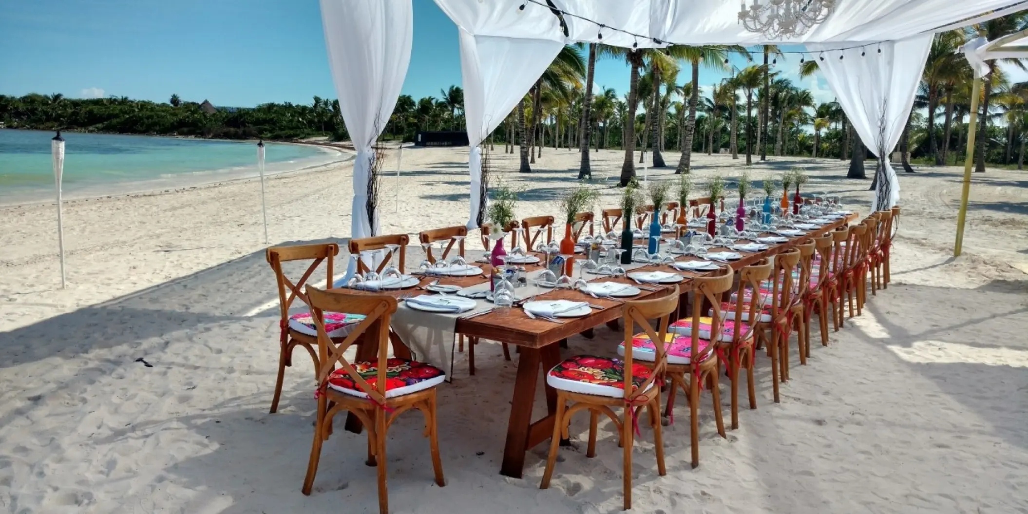 Beachfront wedding reception setup under a white canopy at Barcelo Maya Riviera, Riviera Maya