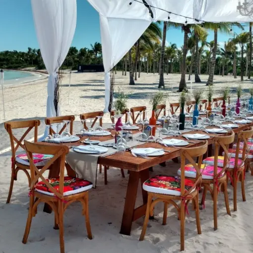 Beachfront wedding reception setup under a white canopy at Barcelo Maya Riviera, Riviera Maya