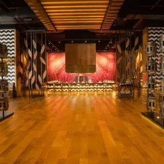 Modern restaurant interior with decorative barrels and wood flooring at Barcelo Maya Riviera, Riviera Maya