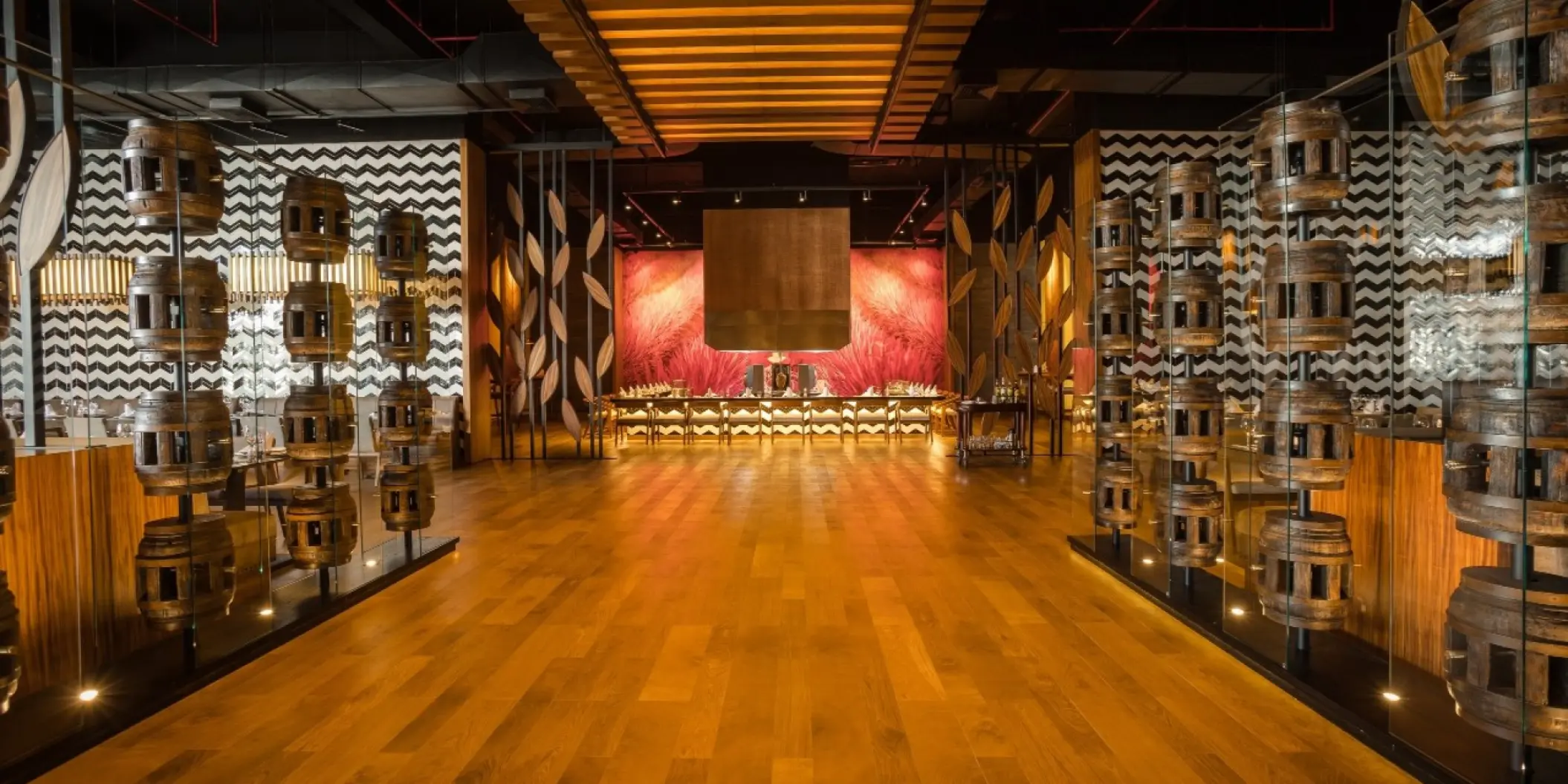 Modern restaurant interior with decorative barrels and wood flooring at Barcelo Maya Riviera, Riviera Maya