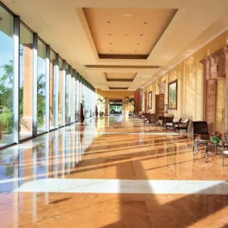 Polished marble hallway with floor-to-ceiling windows at Barcelo Maya Tropical, Riviera Maya