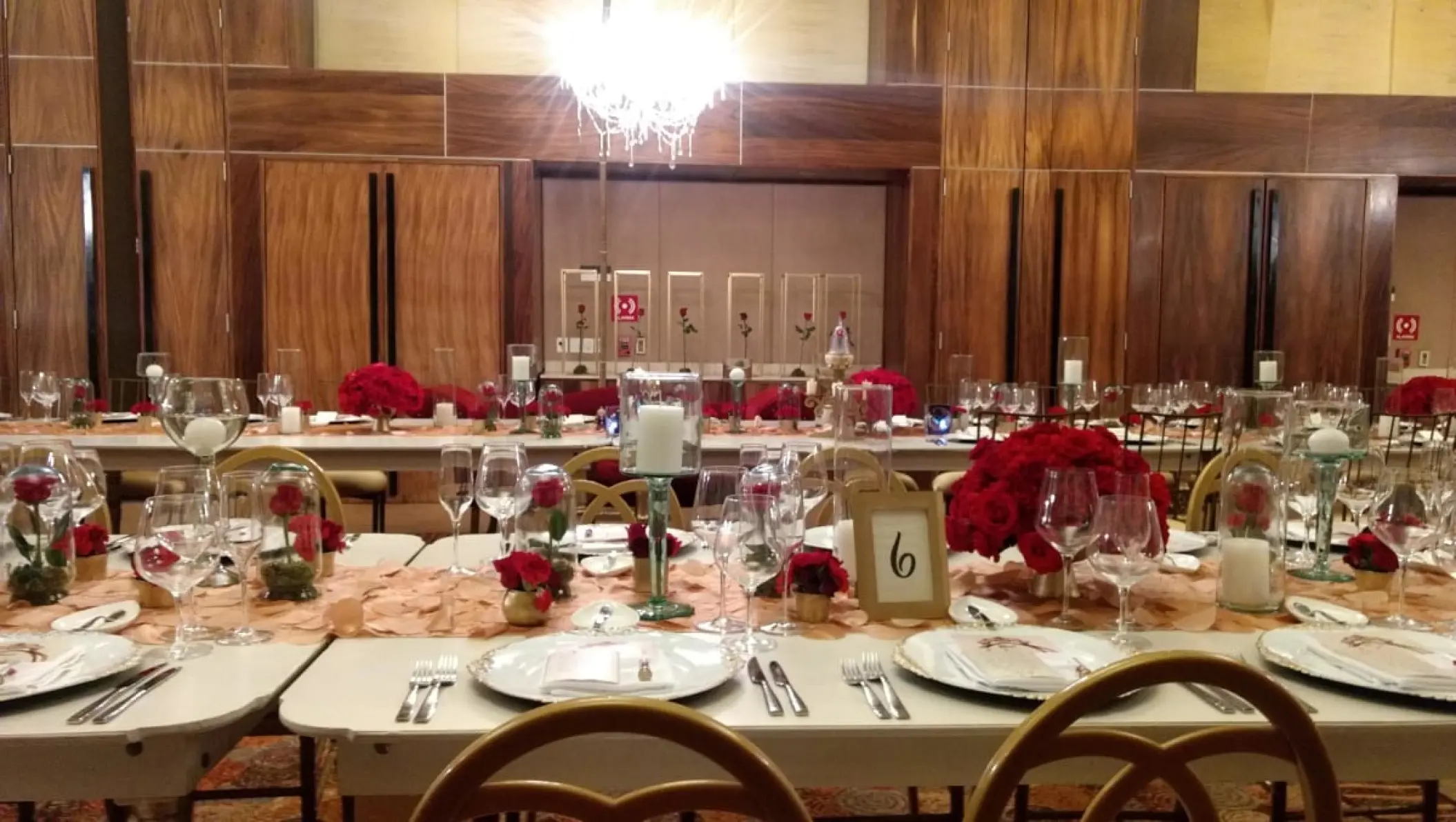 Indoor ballroom wedding reception with red roses and white candles at Blue Diamond Luxury Boutique, Playa Del Carmen
