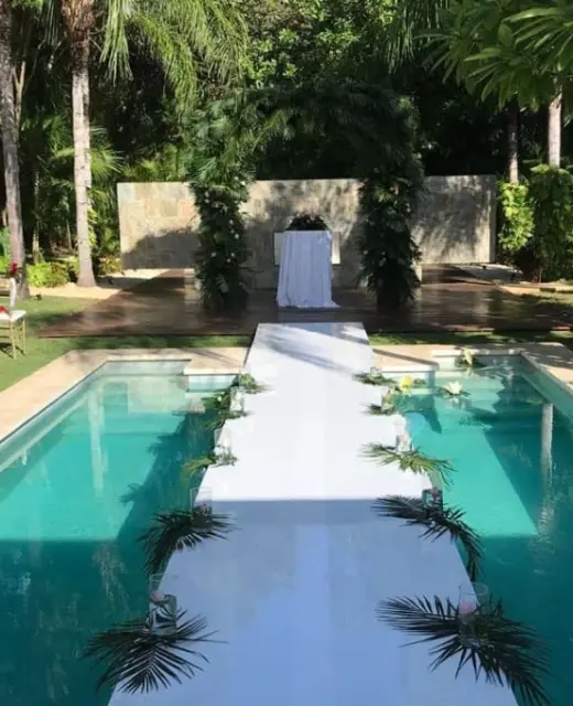 Poolside wedding ceremony with a white aisle walkway at Blue Diamond Luxury Boutique Hotel, Playa Del Carmen
