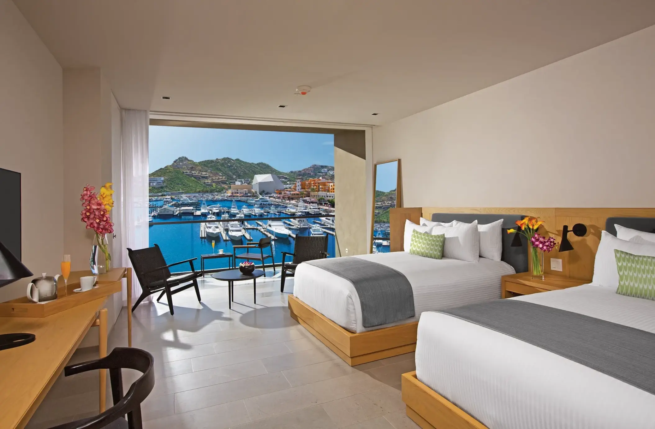 Allure suite with two beds and private balcony overlooking the marina at Breathless Cabo San Lucas