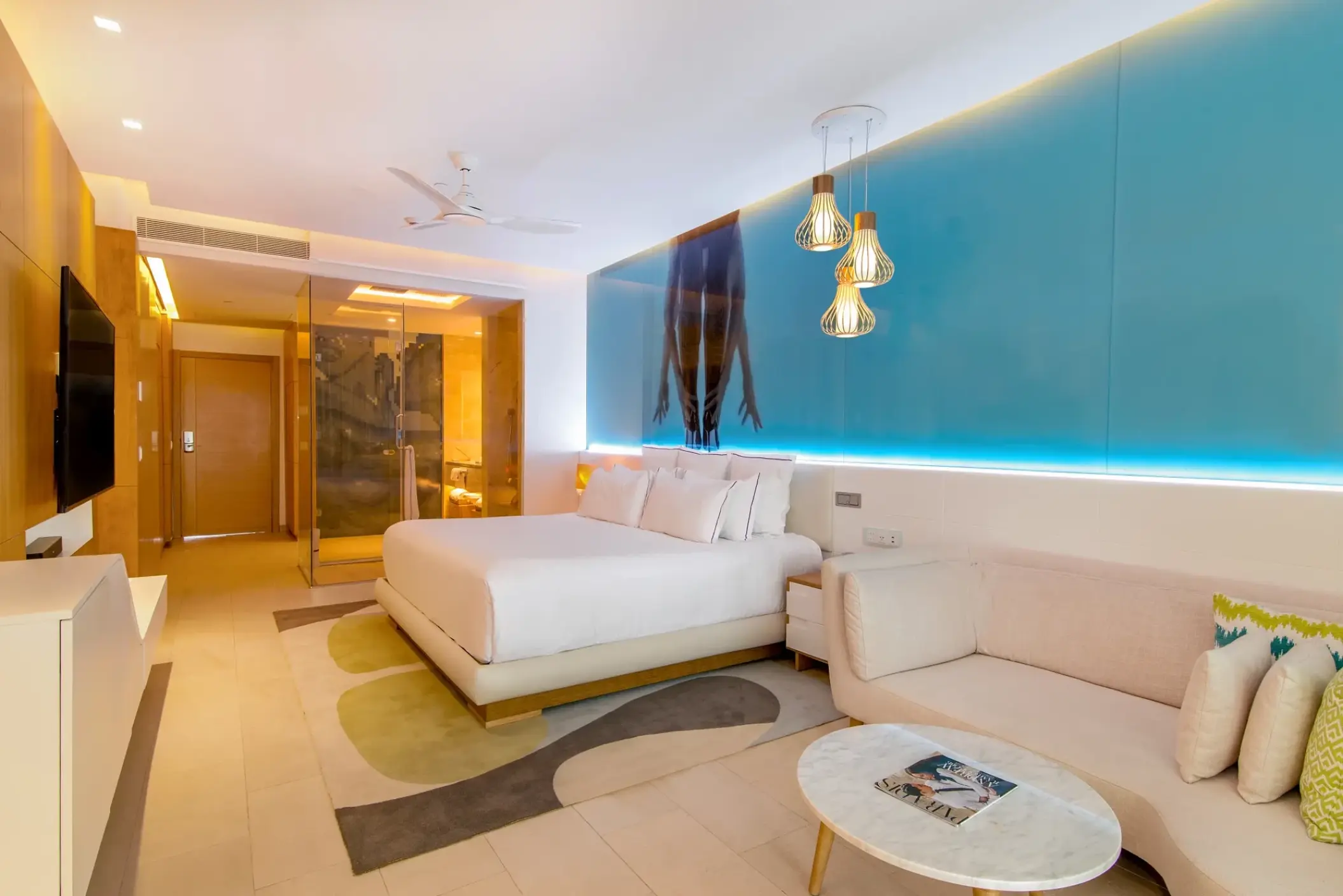 Modern junior suite with a king bed and turquoise accent wall at Breathless Montego Bay, Montego Bay
