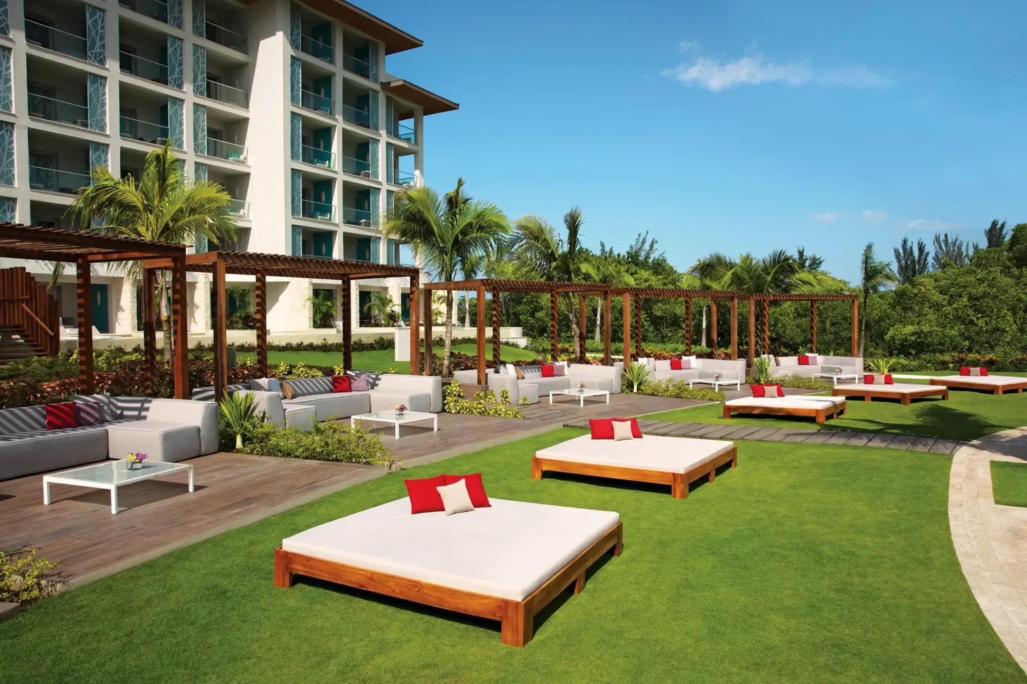 Outdoor lounge area with daybeds and cabanas at Breathless Montego Bay, Montego Bay