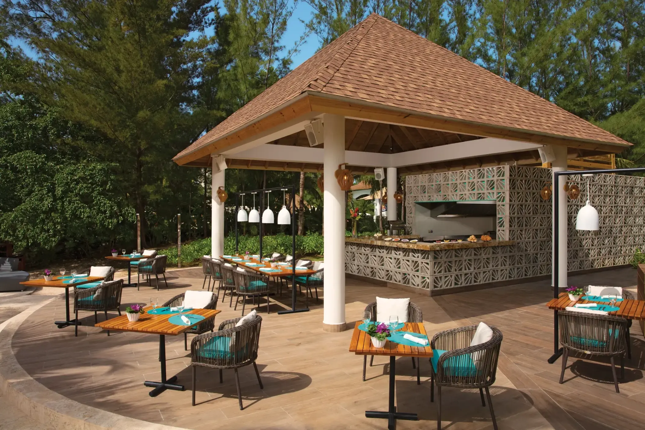 Outdoor dining area and bar with a tiled grill station at Breathless Montego Bay, Montego Bay