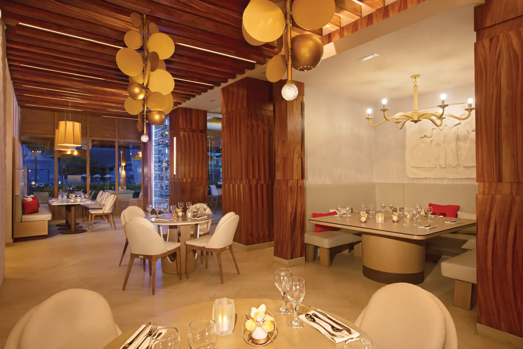 Modern restaurant dining room with wood paneling and gold light fixtures at Breathless Montego Bay, Montego Bay