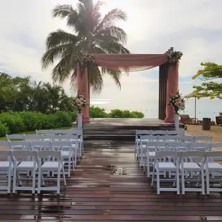 Beachfront wedding ceremony setup with pink draped gazebo and white chairs at Breathless Montego Bay, Jamaica