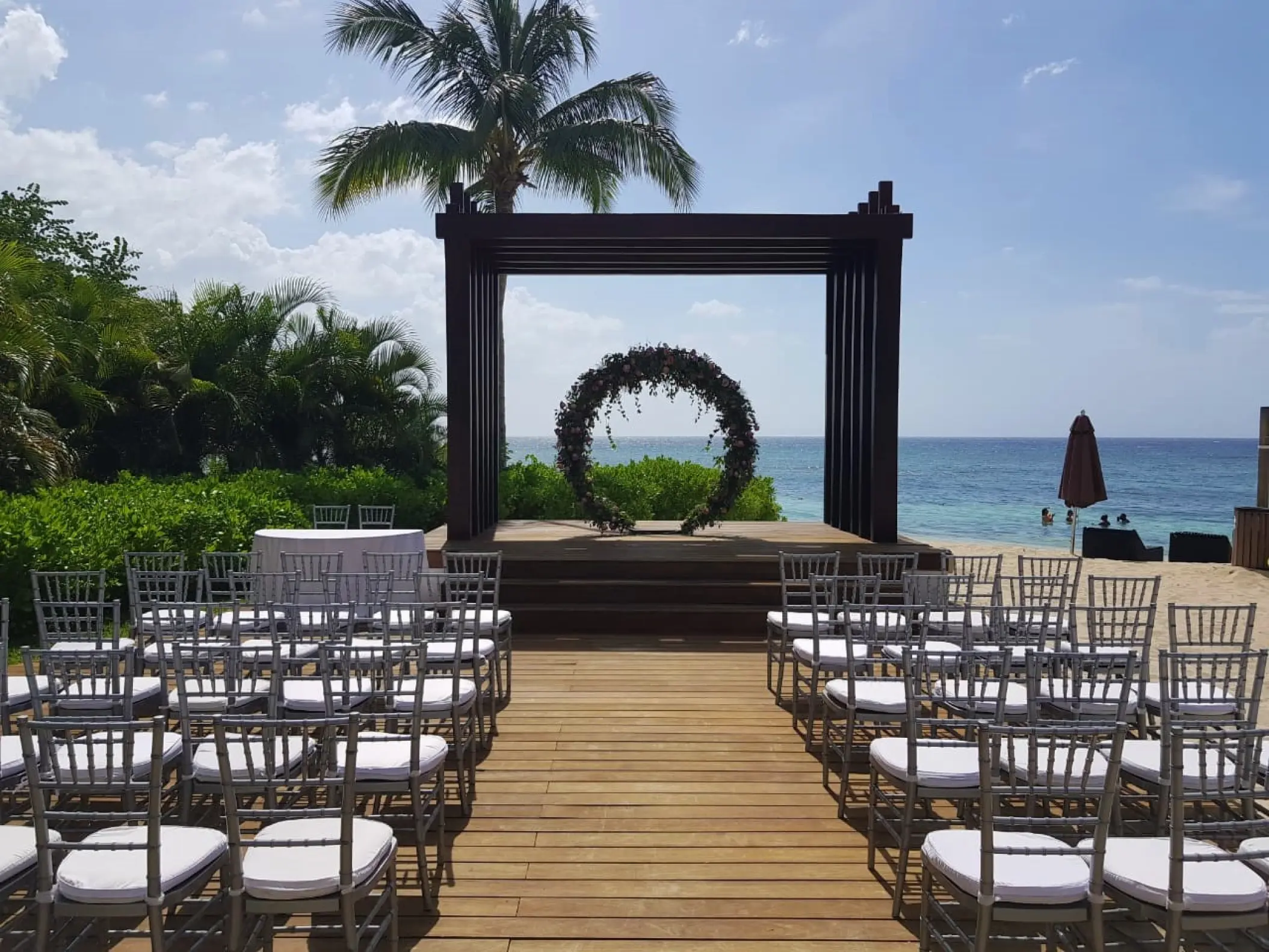 Beachfront wedding ceremony setup with circular floral arch at Breathless Montego Bay, Montego Bay