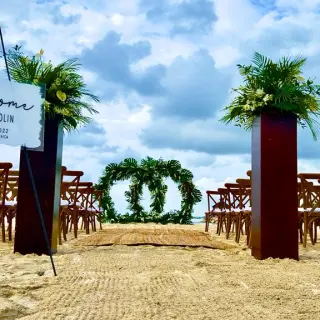 Beachfront wedding ceremony with circular greenery arch at Breathless Montego Bay, Jamaica