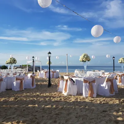 Beach wedding reception with white lanterns and floral centerpieces at Breathless Montego Bay