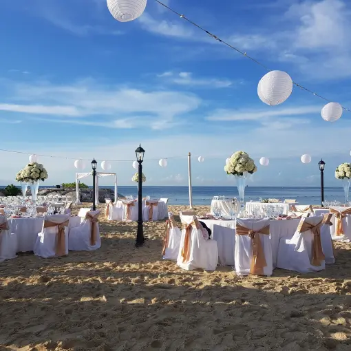 Beach wedding reception with white lanterns and floral centerpieces at Breathless Montego Bay