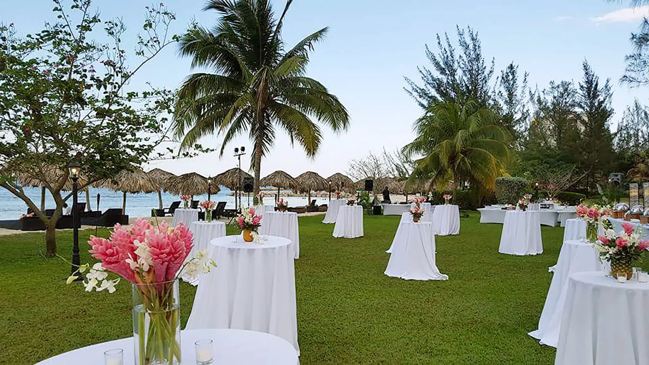 Outdoor wedding reception setup with cocktail tables on a lawn at Breathless Montego Bay, Jamaica