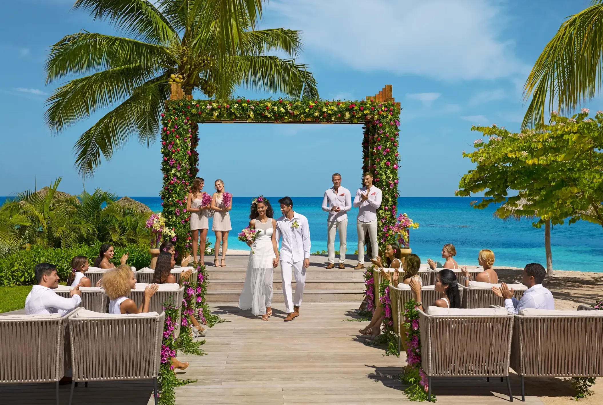 Beachfront wedding ceremony on a wooden deck at Breathless Montego Bay