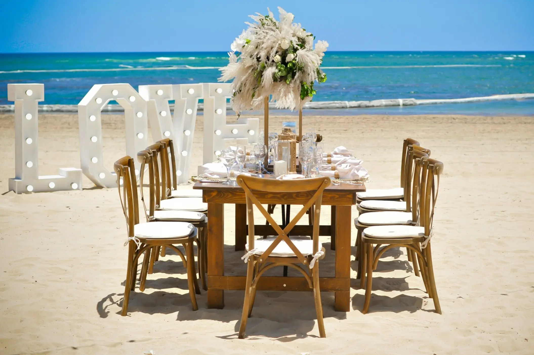 Beachfront wedding reception table with LOVE marquee letters at Breathless Punta Cana, Punta Cana