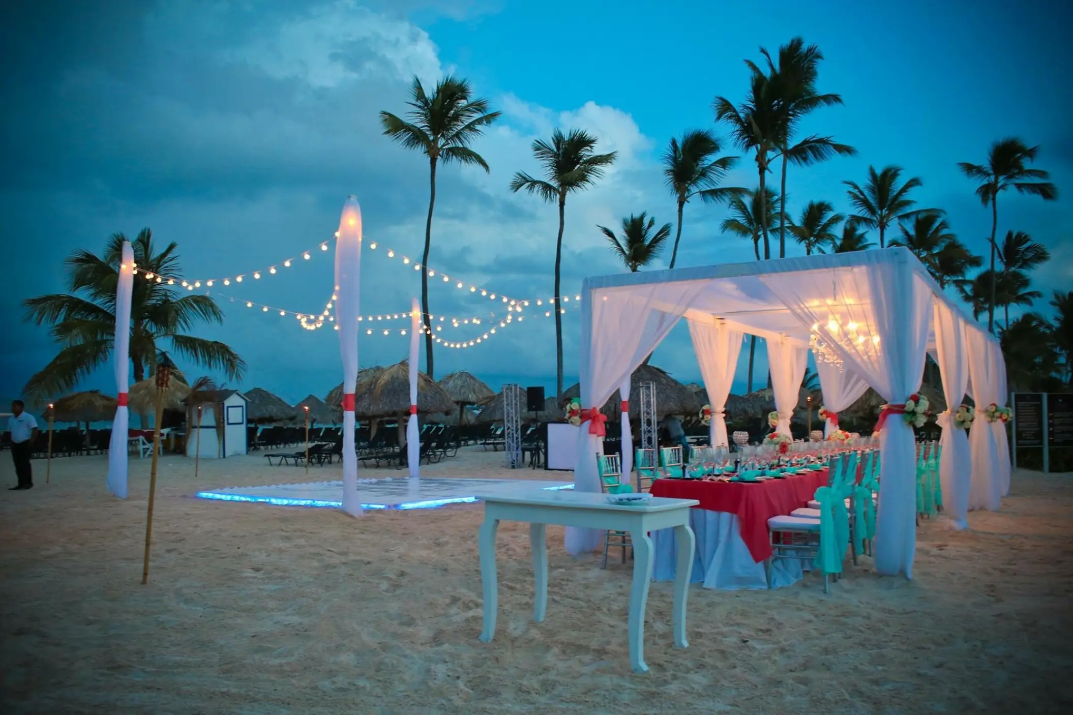 Evening wedding reception under strings of lights on the beach at Breathless Punta Cana