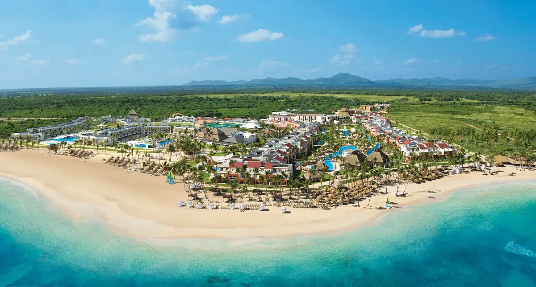 Aerial view of Breathless Punta Cana beachfront buildings and pools along the Caribbean coast, Punta Cana