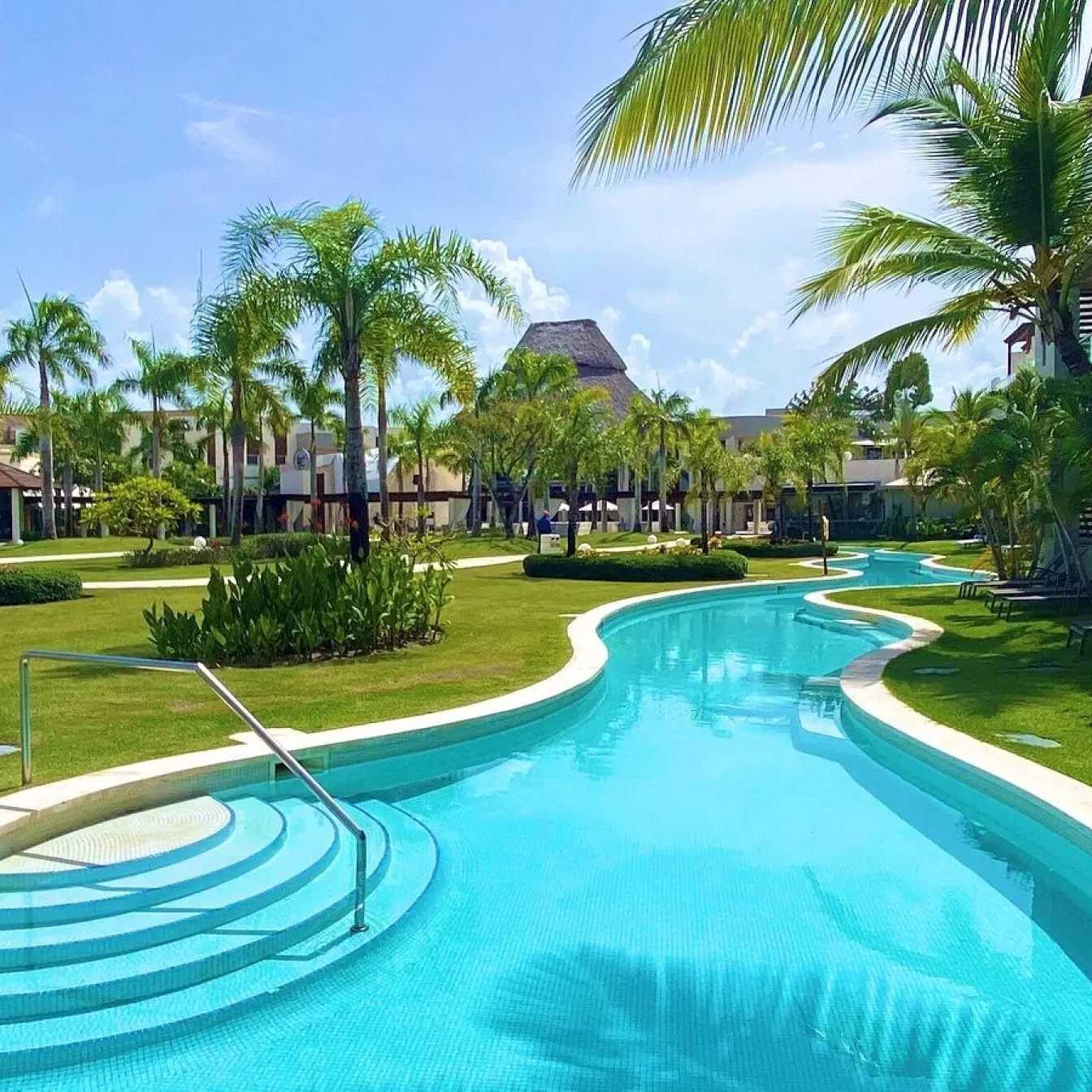 Breathless Punta Cana winding swimming pool surrounded by palm trees and lawns, Punta Cana