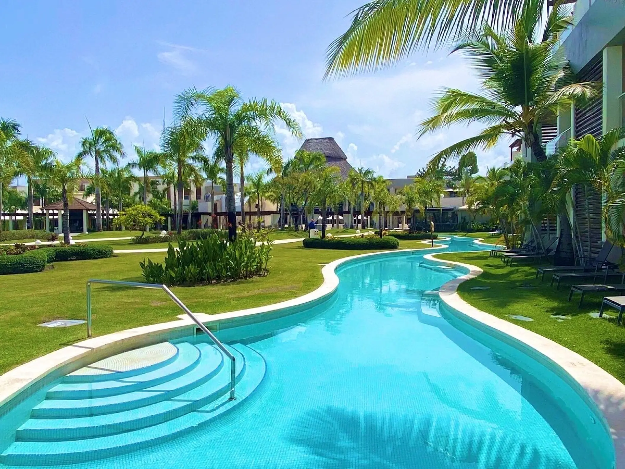 Breathless Punta Cana winding swimming pool surrounded by palm trees and lawns, Punta Cana