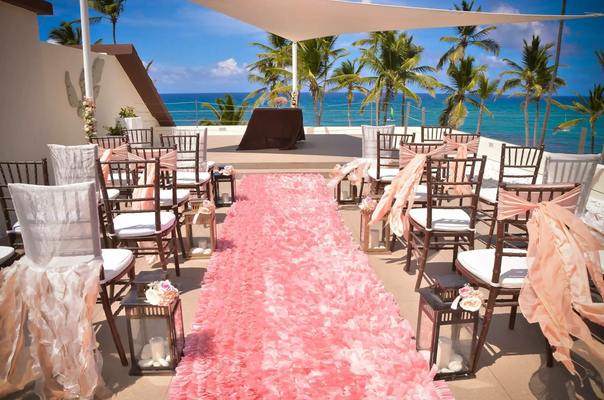 Rooftop wedding ceremony with pink runner and ocean views at Breathless Punta Cana
