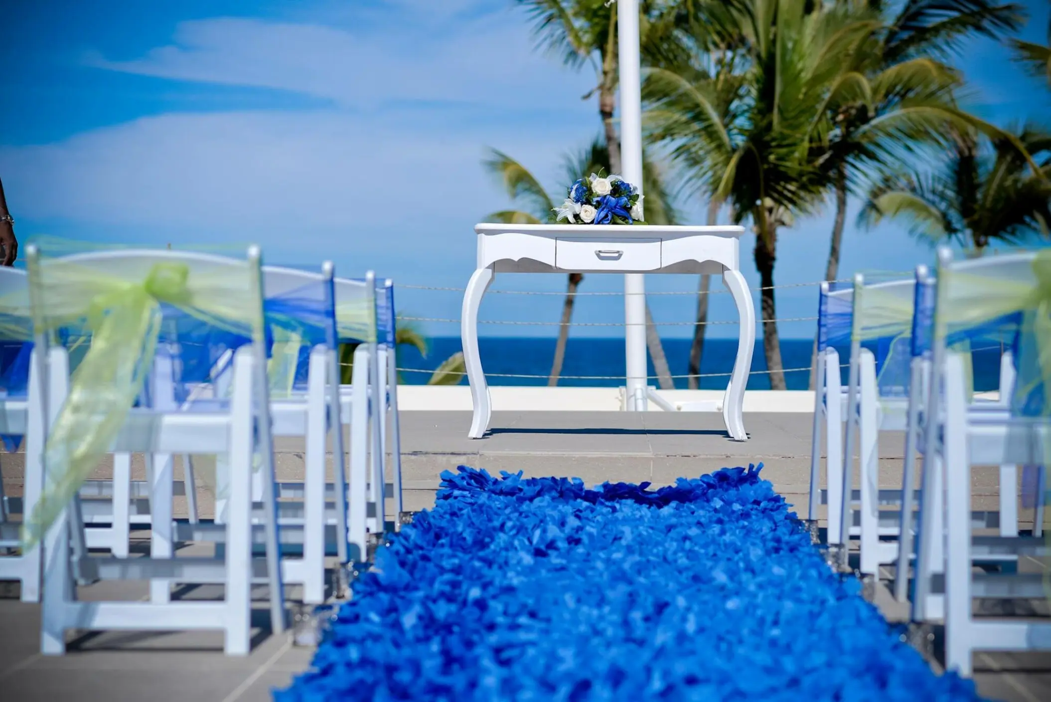Rooftop wedding ceremony with blue aisle and white altar table at Breathless Punta Cana