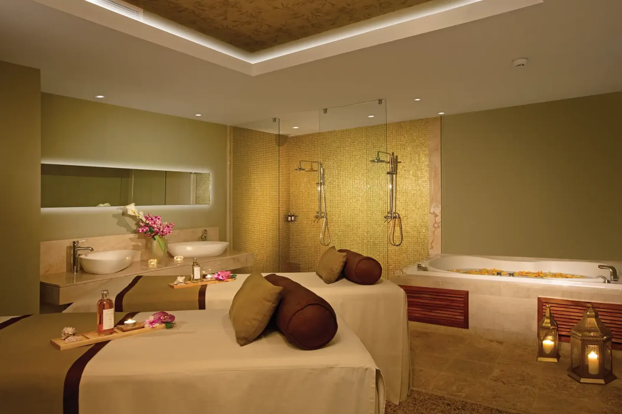 Couples massage room with dual treatment tables and a whirlpool tub at Breathless Punta Cana