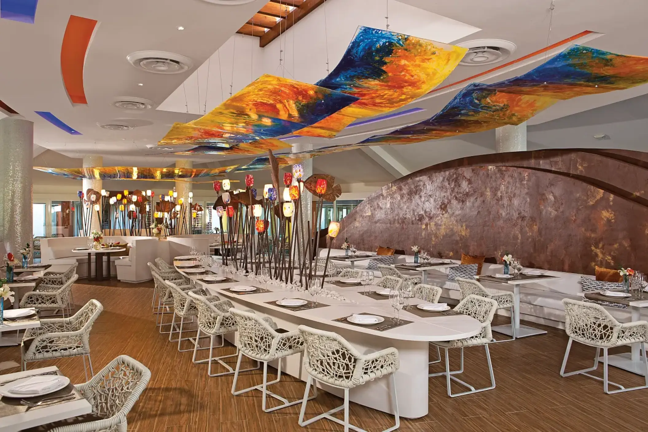 Spumante restaurant interior with colorful ceiling art at Breathless Punta Cana