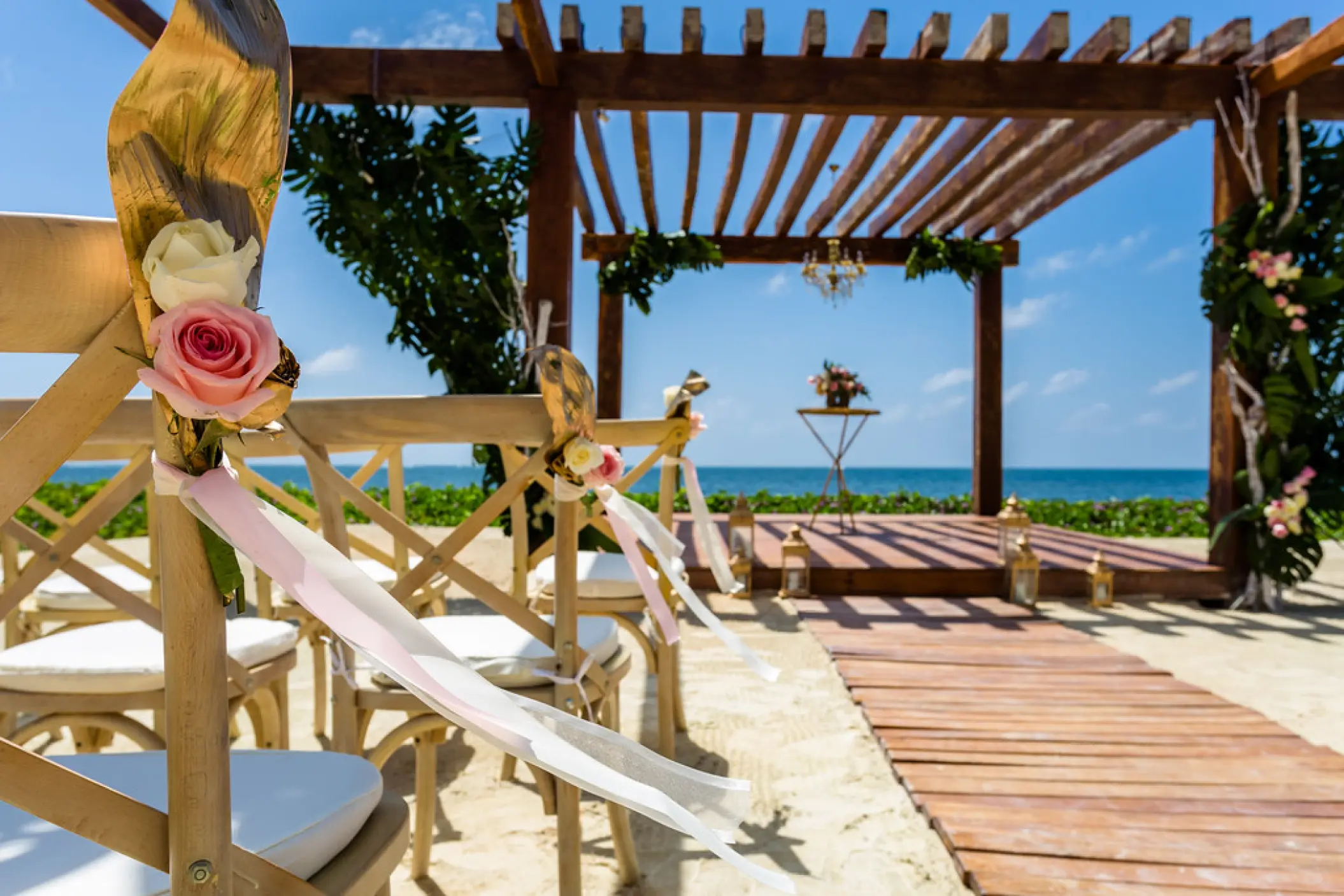 Beachfront wedding ceremony under a wooden pergola at Breathless Riviera Cancun, Riviera Maya