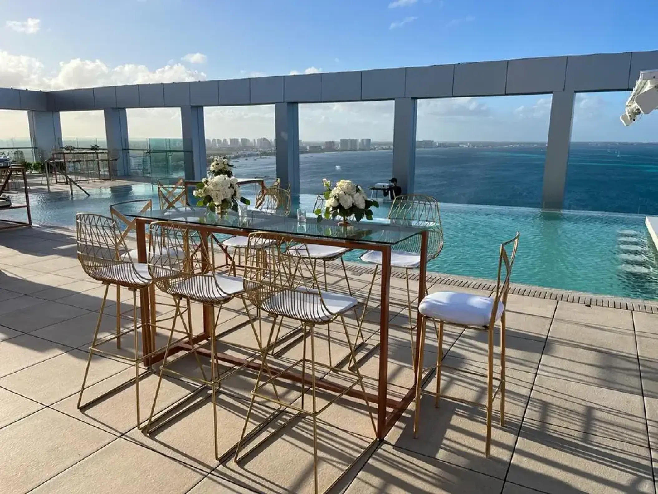 Rooftop wedding reception terrace with gold chairs and ocean views at Breathless Cancun Soul, Cancun