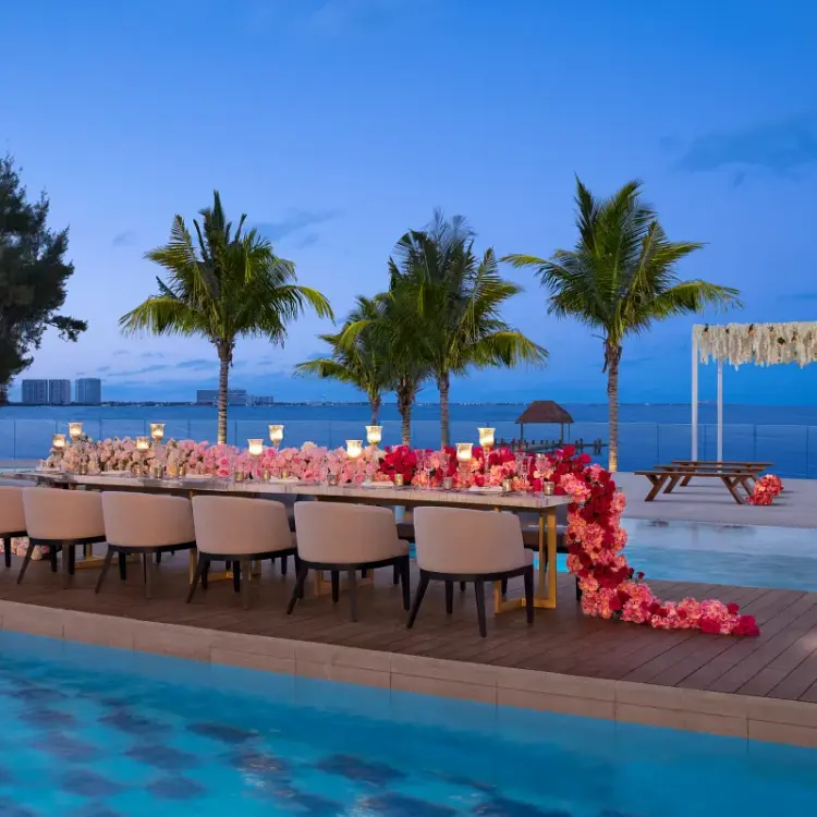 Rooftop wedding reception with floral decor and pool view at Breathless Cancun Soul, Cancun