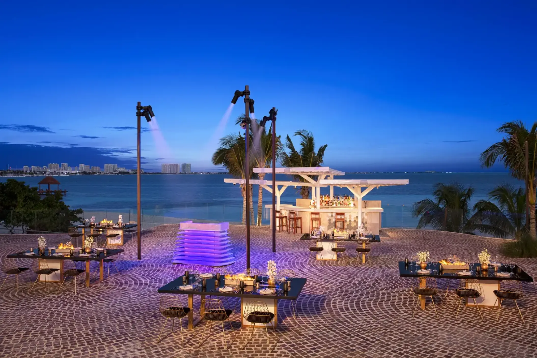 Rooftop terrace with tables and bar at Breathless Cancun Soul, Cancun