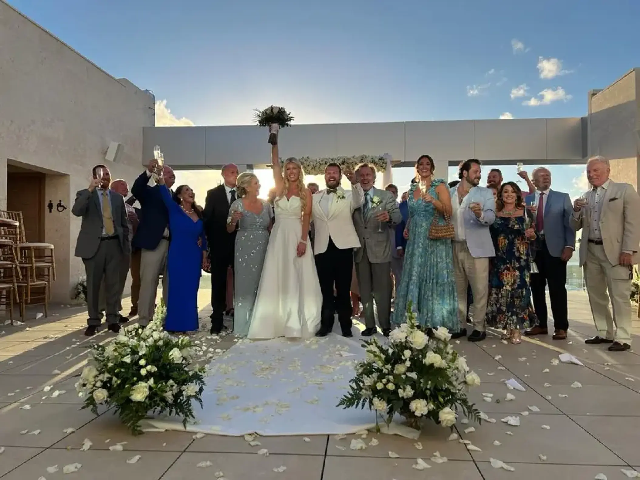 The couple and their guests cheering at a rooftop wedding ceremony at Breathless Cancun Soul, Cancun