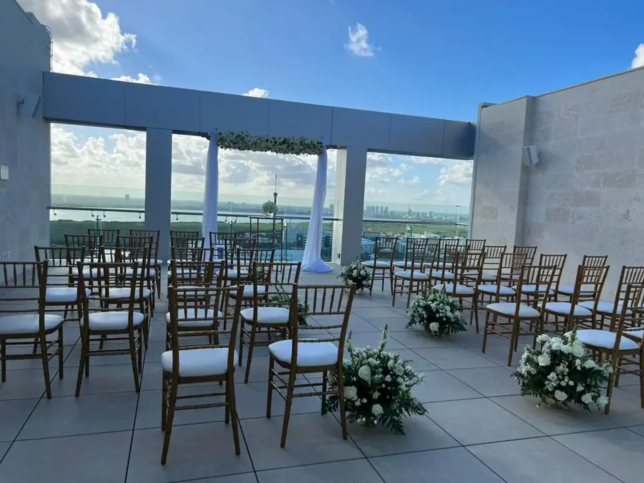 Rooftop wedding ceremony setup with white floral arrangements at Breathless Cancun Soul, Cancun