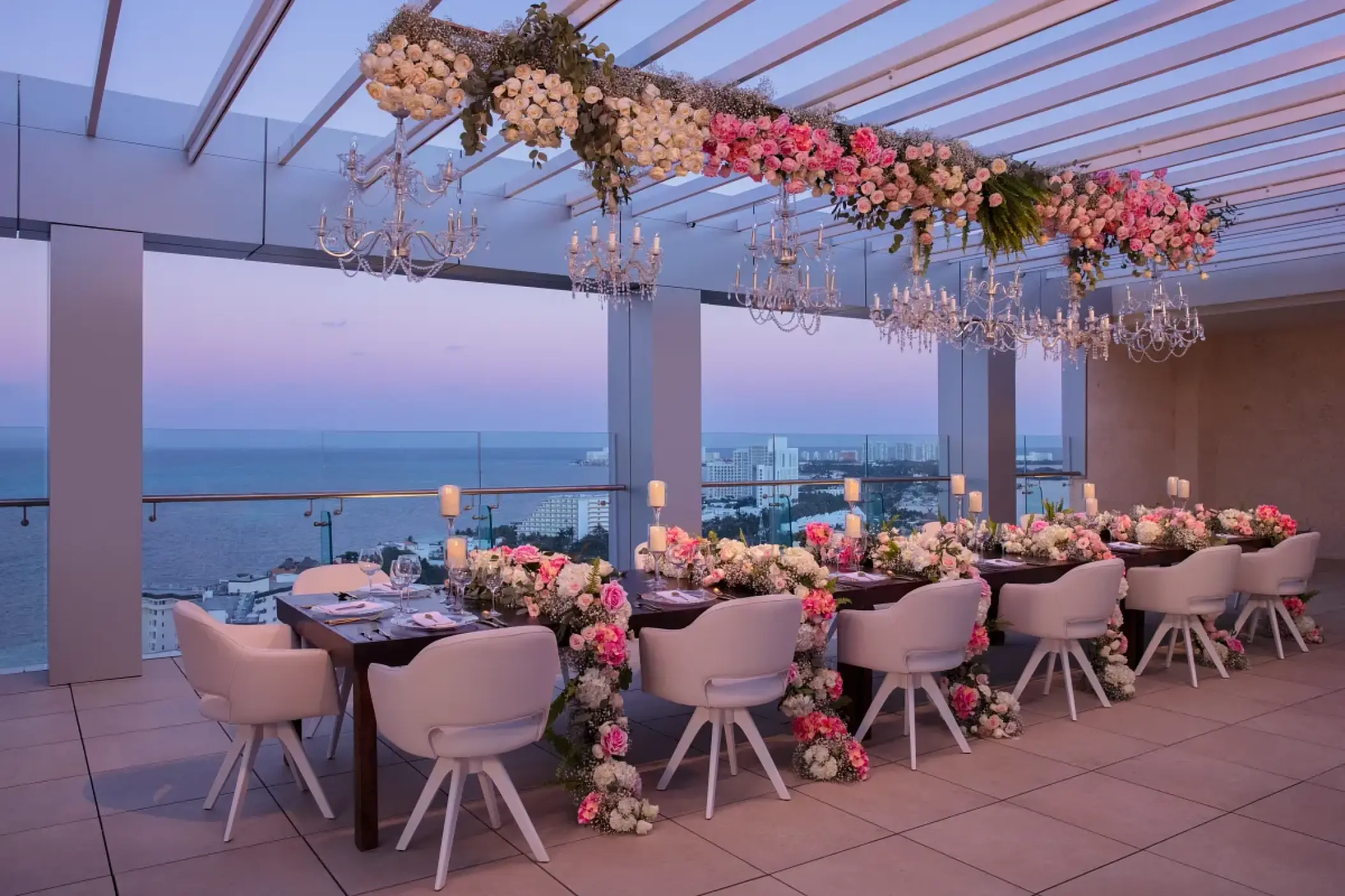 Rooftop wedding reception with floral runners and crystal chandeliers at Breathless Cancun Soul, Cancun
