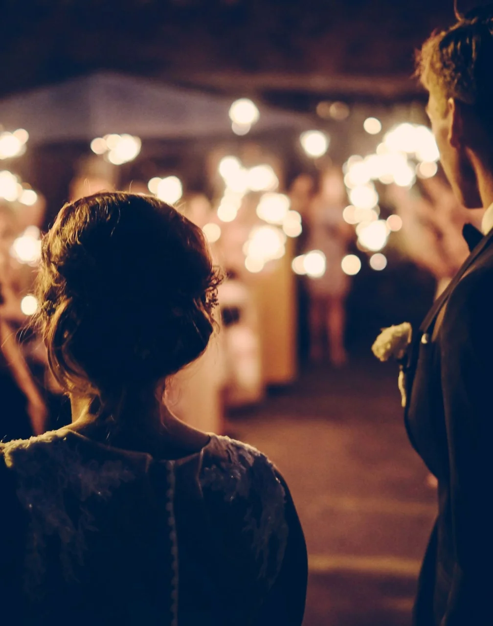 bride and groom and guests holding sparklers