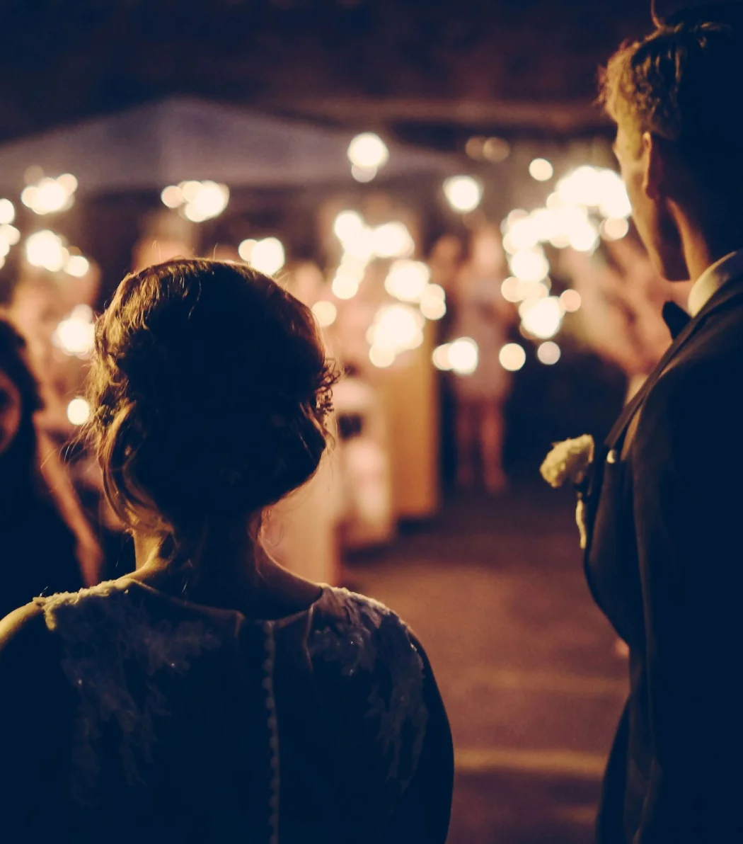 bride and groom and guests holding sparklers