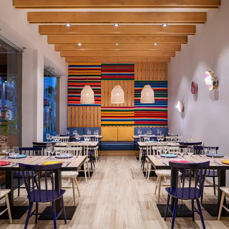 Adelita restaurant dining area with colorful decor and wood-beamed ceiling at Catalonia Grand Costa Mujeres, Cancun