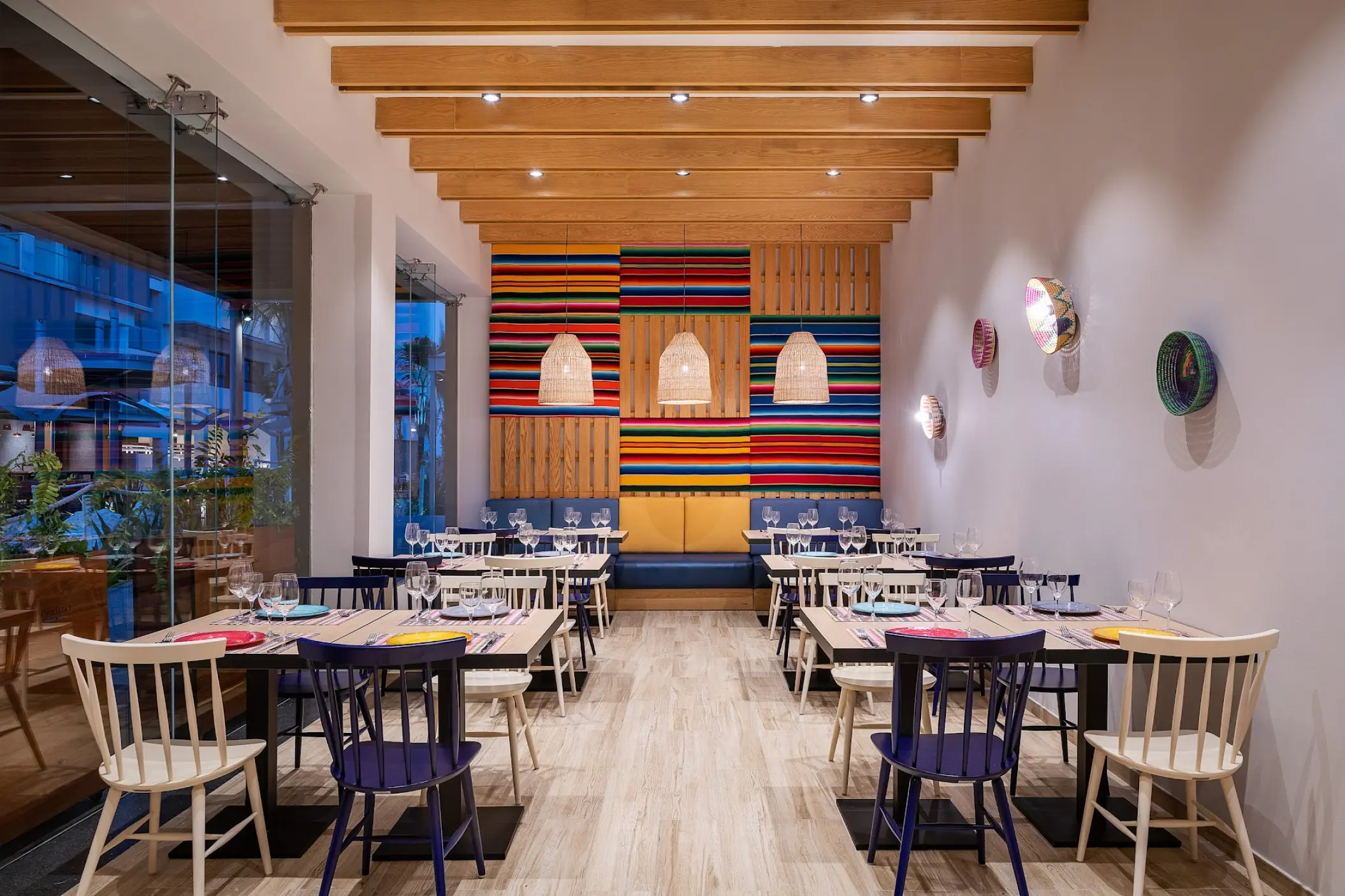Adelita restaurant dining area with colorful decor and wood-beamed ceiling at Catalonia Grand Costa Mujeres, Cancun