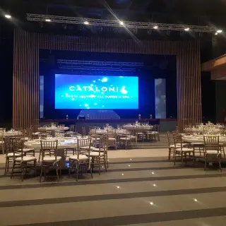 Ballroom wedding reception setup with circular tables and stage at Catalonia Grand Costa Mujeres, Cancun