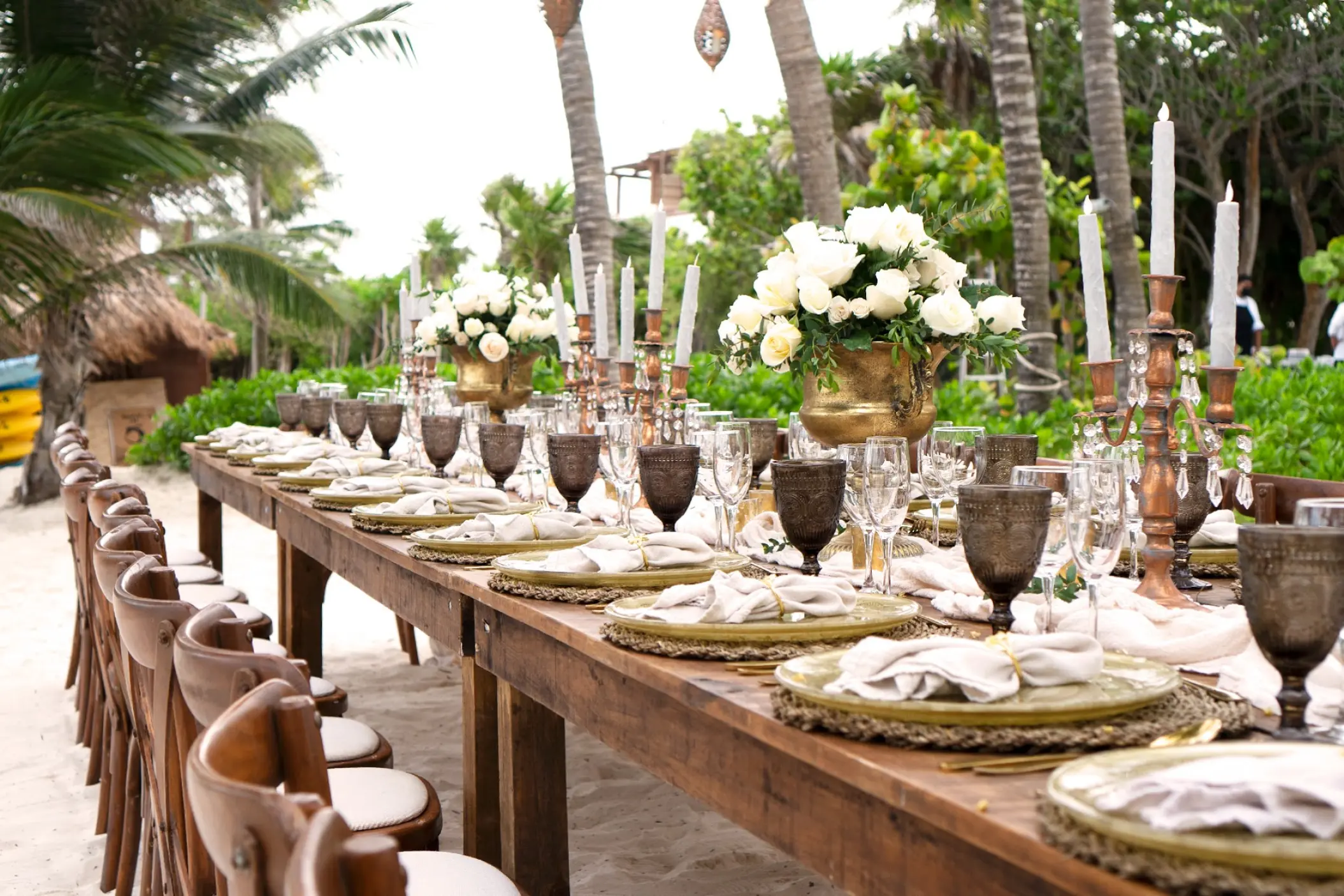 Long wooden table set for a beach wedding reception at Catalonia Grand Costa Mujeres, Cancun