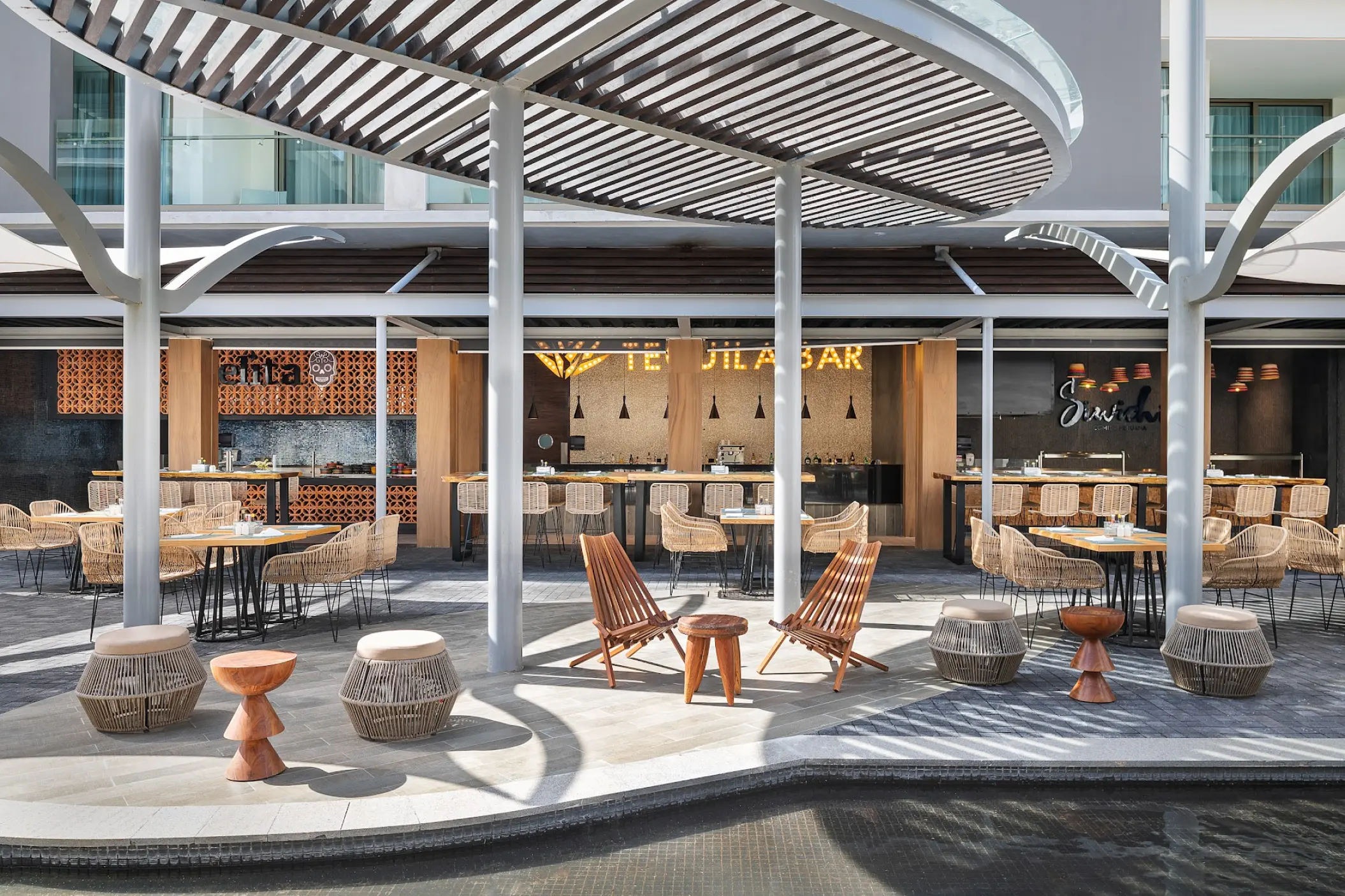 Outdoor food court and Tequila Bar with modern wooden seating at Catalonia Grand Costa Mujeres, Cancun