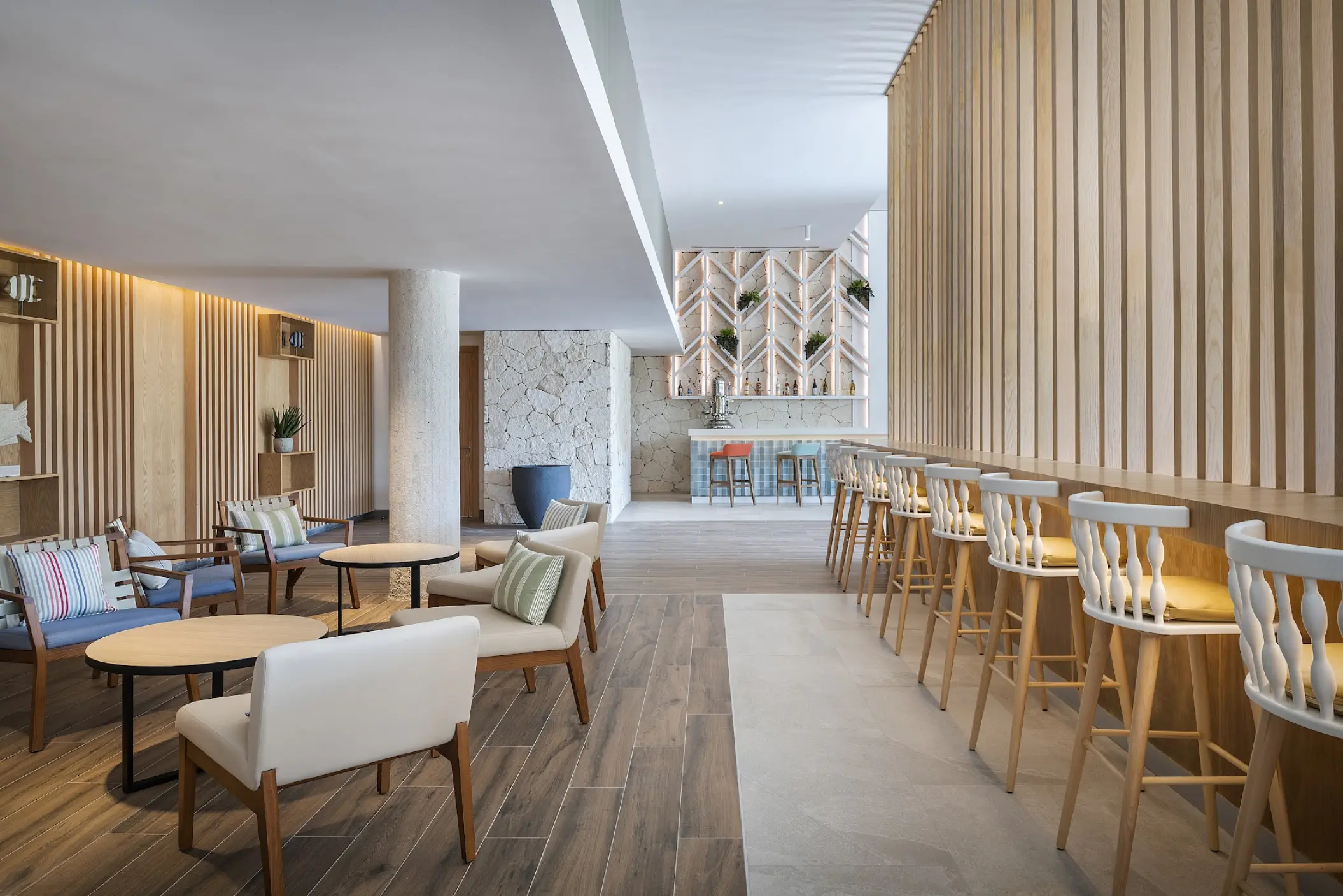 Modern lobby lounge and bar with wood accents at Catalonia Grand Costa Mujeres, Cancun