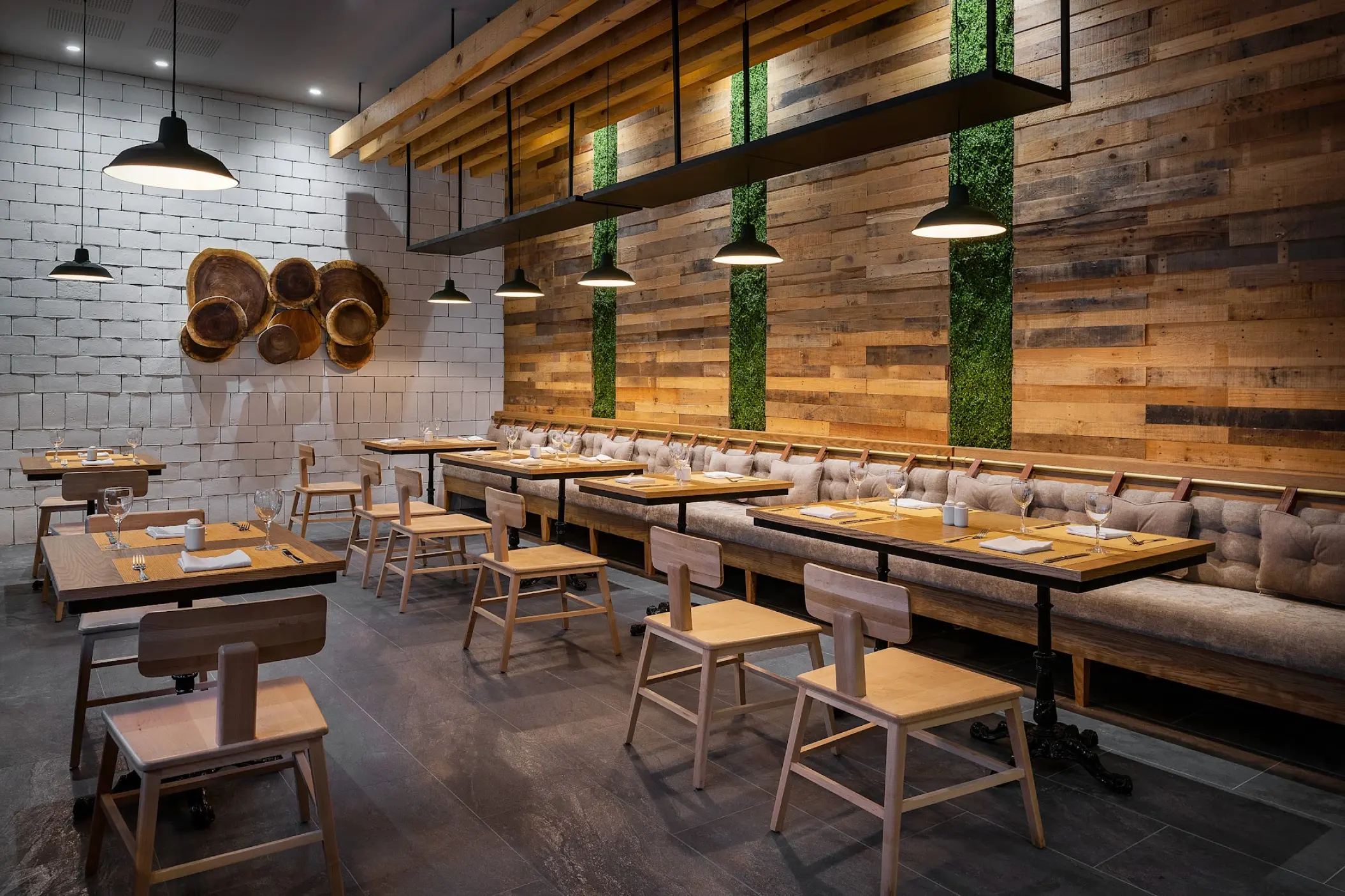 Modern Bo restaurant interior with wooden paneling and vertical greenery at Catalonia Grand Costa Mujeres, Cancun